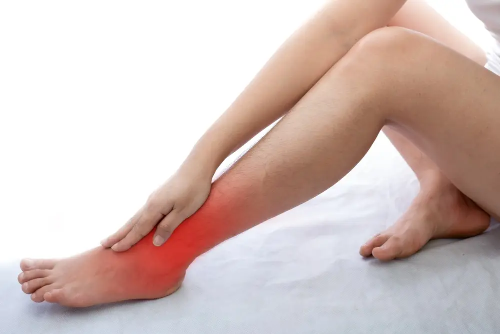 Stiff ankles in the morning: 5 common causes and treatments that can help young woman with ankle pain at white background 2022 11 02 16 31 14 utc 1 Stiff ankles in the morning: 5 common causes and treatments that can help
